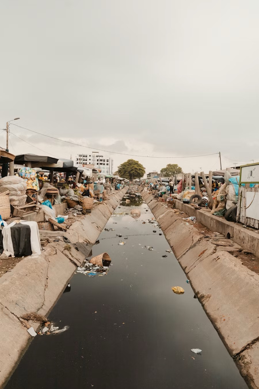 A polluted waterway and drain in a Ghanaian market area